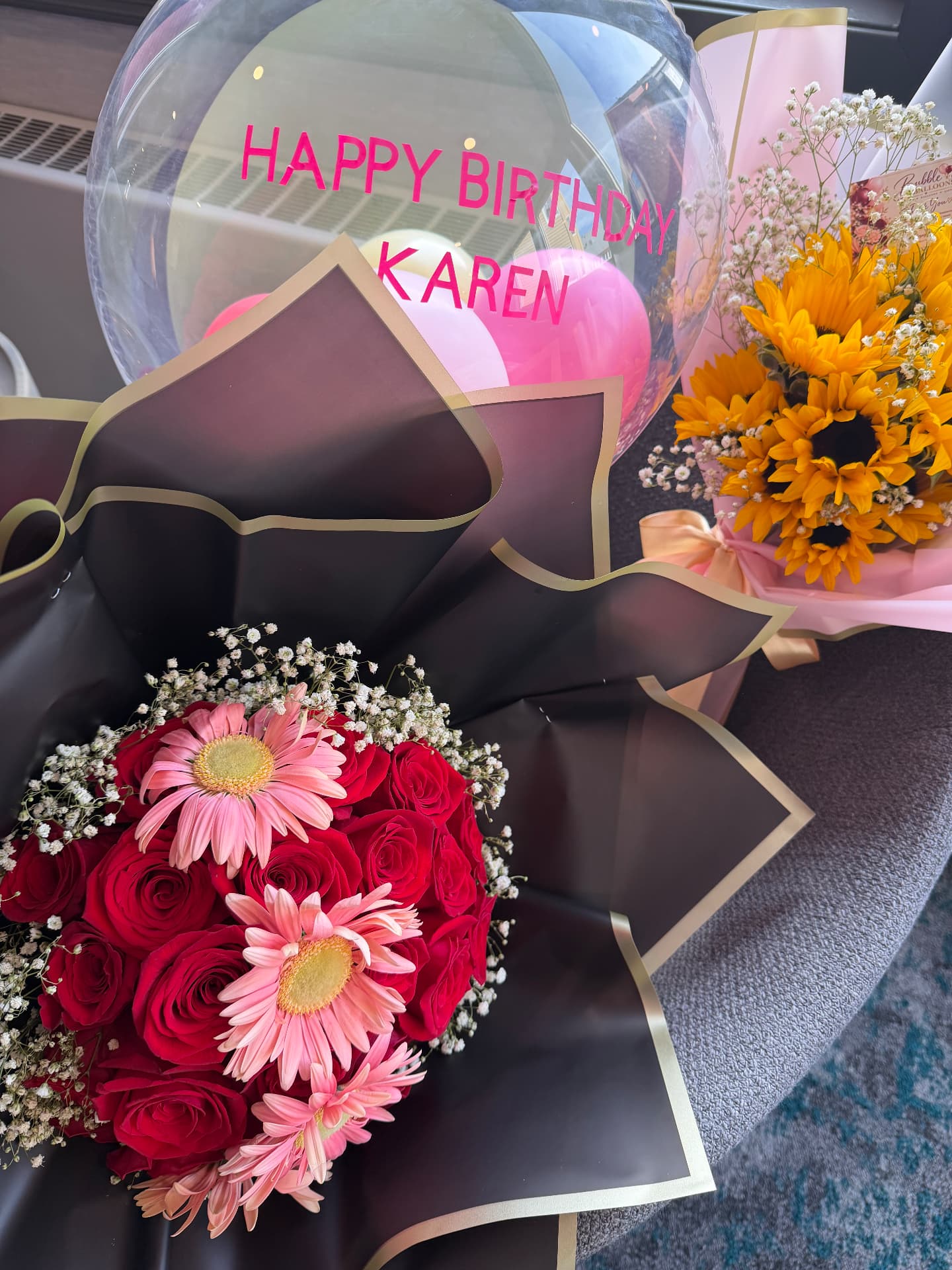 Red rose and pink gerbera bouquet with birthday balloon