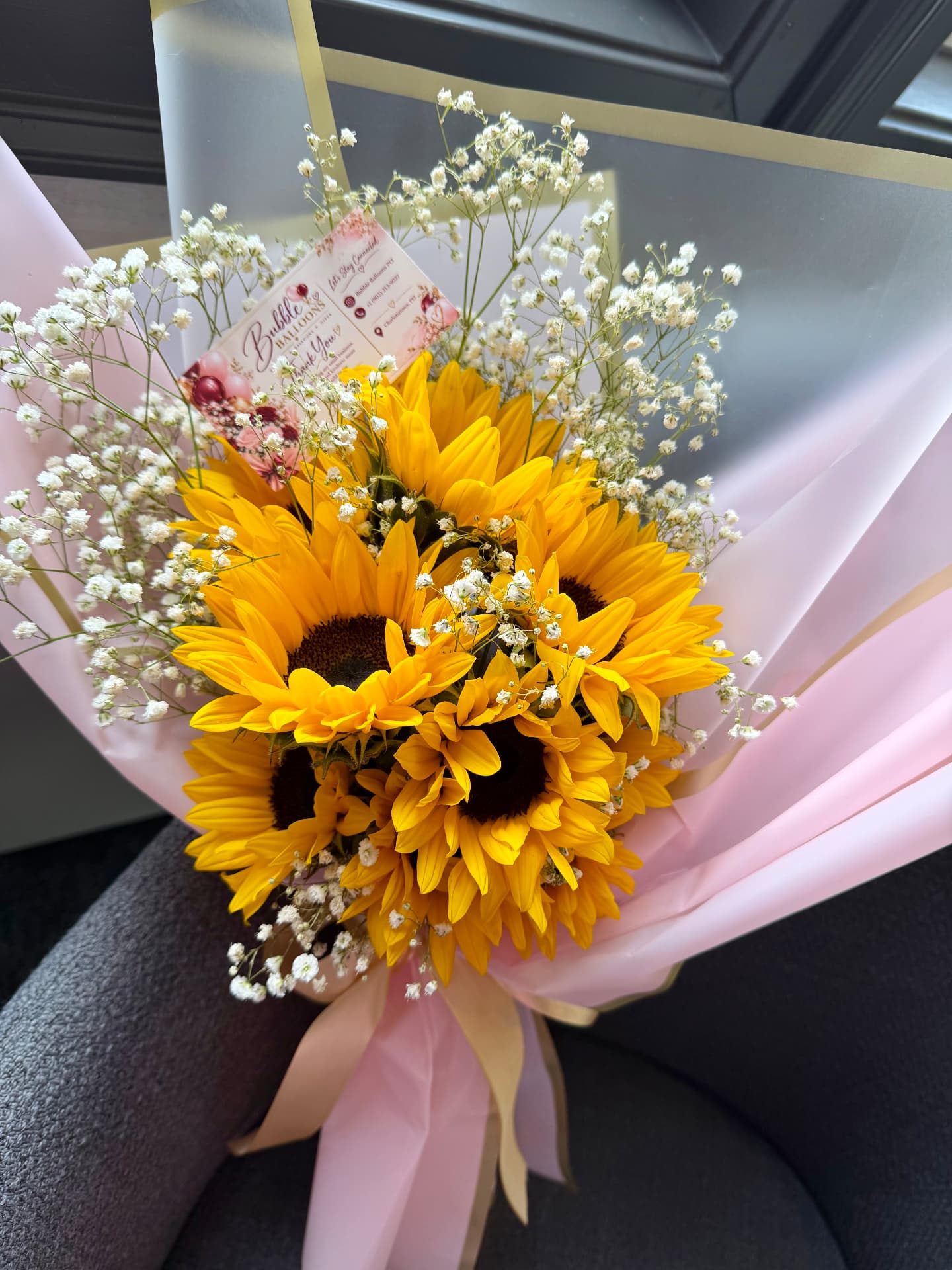 Sunflower bouquet with baby's breath in pink wrap