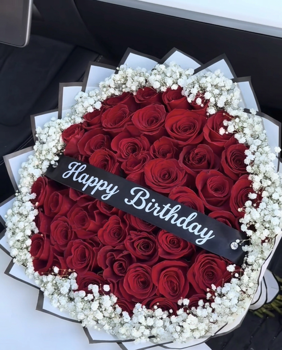 Red rose bouquet with a Happy Birthday banner